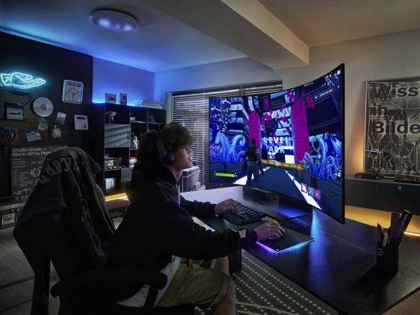 man viewing game on curved Odyssey monitor